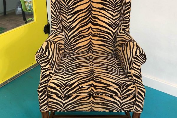 An armchair with tiger print upholstery.