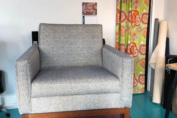 A modern gray upholstered armchair.