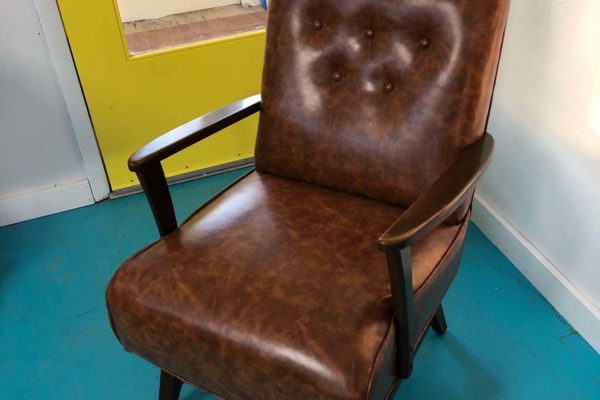 A leather upholstered arm chair.