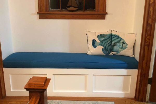 Blue upholstered cushion for a white farmhouse bench
